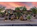 Desert landscaping in front of home, creating a beautiful curb appeal with native plants and modern architectural design at 7848 E Parkview Ln, Scottsdale, AZ 85255