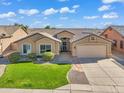 Well-maintained one-story home featuring desert landscaping, a green lawn, and a two-car garage at 8531 E Natal Cir, Mesa, AZ 85209