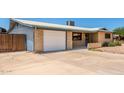 A single story home featuring a driveway and attached garage, and brick accents at 900 S Palo Verde Dr, Apache Junction, AZ 85120