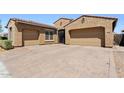 Beautiful home featuring a desert-landscaped front yard and an attached three-car garage at 10220 E Thatcher Ave, Mesa, AZ 85212