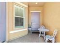 Cozy porch with a small table and chairs, perfect for enjoying a morning coffee or an evening sunset at 10220 E Thatcher Ave, Mesa, AZ 85212
