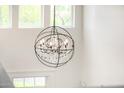 Wrought iron and crystal chandelier in entry above stairwell with window at 122 W Cottage Ln, Tempe, AZ 85282