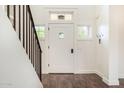 Inviting foyer featuring hardwood floors and a staircase leading to upper level at 122 W Cottage Ln, Tempe, AZ 85282