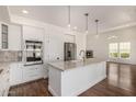 Open-concept kitchen featuring a kitchen island, marble counters, and stainless steel appliances at 122 W Cottage Ln, Tempe, AZ 85282