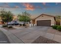 Exterior shot of a single Gathering home with desert landscaping and a two car garage at 20848 E Desert Hills Blvd, Queen Creek, AZ 85142