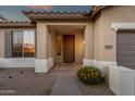 Inviting front porch with a tidy walkway, desert landscaping, and a secure front door at 20848 E Desert Hills Blvd, Queen Creek, AZ 85142