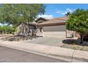 This single-story home boasts a tile roof, an attached two-car garage, and drought-tolerant landscaping in the front yard at 2260 E Binner Dr, Chandler, AZ 85225