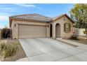 Charming single-story home with a tile roof, two-car garage, and well-maintained front yard at 26232 N 121St Ln, Peoria, AZ 85383