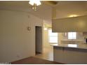 Open living room featuring a kitchen and adjacent room with bright lighting at 2650 W Union Hills Dr # 43, Phoenix, AZ 85027