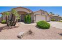 Charming single-story home with a well-manicured desert landscape and a three car garage at 343 S Cottonwood St, Chandler, AZ 85225