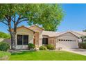 Attractive front of home with well-maintained landscaping, mature tree, and spacious two-car garage at 531 N Cambridge St, Gilbert, AZ 85233