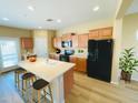 Bright kitchen features an island with bar seating, modern appliances, and lots of cabinet space at 5743 W Gwen St, Laveen, AZ 85339