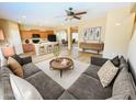 Open-concept living room showcasing wood floors, modern furnishings, and seamless flow to the kitchen at 5743 W Gwen St, Laveen, AZ 85339
