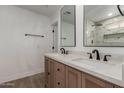 Bathroom featuring a double vanity, tile shower and framed mirrors at 6607 S Mitchell Dr, Tempe, AZ 85283