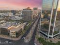 Aerial view of an urban area featuring modern buildings, light rail, and lush landscaping at 1 E Lexington Ave # 1302, Phoenix, AZ 85012