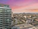 Scenic aerial view of the city with desert mountains in the background at sunset at 1 E Lexington Ave # 1302, Phoenix, AZ 85012