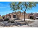 Charming single-story home featuring a well-manicured front yard and an attached two-car garage at 12469 W Hearn Rd, El Mirage, AZ 85335