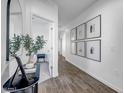 Bright hallway with wood-look tile flooring and decorative artwork at 1482 W Gloucester W Rd, San Tan Valley, AZ 85143