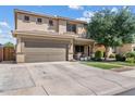 Inviting home featuring an attached two-car garage and well-maintained landscaping for great curb appeal at 1518 W Crape Rd, San Tan Valley, AZ 85140