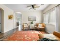 Bright living room featuring hardwood floors, a decorative rug, and comfortable seating, perfect for gatherings at 1518 W Crape Rd, San Tan Valley, AZ 85140