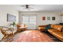 Inviting living room with hardwood floors, a plush sofa, and ample natural light, creating a cozy atmosphere at 1518 W Crape Rd, San Tan Valley, AZ 85140