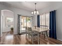 Bright dining room with modern lighting and sliding glass doors at 15246 N 138Th Ln, Surprise, AZ 85379