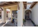 Inviting covered front porch with rocking chairs and desert landscaping leading to the front door at 15246 N 138Th Ln, Surprise, AZ 85379