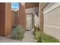 The welcoming front porch features a beautiful agave plant and flowering bushes alongside the walkway at 16450 E Avenue Of The Fountain -- # 47, Fountain Hills, AZ 85268