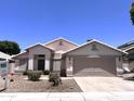 Charming single-story home with a well-maintained front yard and a two-car garage at 1704 E Redfield Rd, Gilbert, AZ 85234
