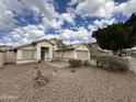 Charming single-story home featuring a neutral color palette, minimal landscaping and a covered front entrance at 1704 E Redfield Rd, Gilbert, AZ 85234