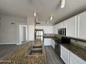 Bright kitchen featuring white cabinets, stainless steel appliances, and a large island with a double sink at 1704 E Redfield Rd, Gilbert, AZ 85234
