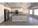Spacious eat-in kitchen with white cabinets, stainless steel appliances, and granite countertops at 1704 E Redfield Rd, Gilbert, AZ 85234