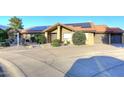 Charming home featuring a tiled roof, solar panels, a two-car garage, and desert landscaping at 17211 N 58Th St, Scottsdale, AZ 85254