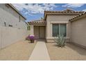 Inviting home featuring a covered entrance, desert landscaping, and a paved walkway at 1744 W Brookwood Ct, Phoenix, AZ 85045