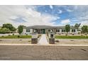 Charming single story home with a gray roof, stone accents, desert landscaping and a welcoming entrance at 19935 E Via Del Palo --, Queen Creek, AZ 85142