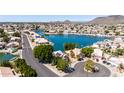 Stunning aerial view of waterfront homes, showcasing a tranquil lake community with lush greenery and convenient street access at 20410 N 51St Dr, Glendale, AZ 85308