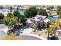 Beautiful two-story home with a three-car garage, desert landscaping and solar panels, all on a picturesque waterfront lot at 20410 N 51St Dr, Glendale, AZ 85308