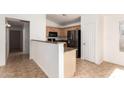 Charming kitchen with stainless steel fridge, granite counters, and neutral cabinets at 2433 W Hayden Peak Dr, San Tan Valley, AZ 85144