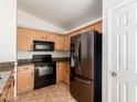 Updated kitchen featuring a stainless steel refrigerator and black appliances at 2433 W Hayden Peak Dr, San Tan Valley, AZ 85144