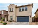 Stylish two-story house showcasing a blue garage door and stucco facade at 2533 W Cordia Ln, Phoenix, AZ 85085