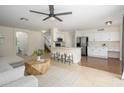 Open-concept kitchen and living area featuring stainless steel appliances, breakfast bar, and ample seating at 25825 N 65Th Ave, Phoenix, AZ 85083