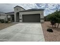 Charming single-story home featuring a two-car garage and desert landscaping at 30395 W Mitchell Ave, Buckeye, AZ 85396