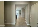 Hallway view with tile flooring leading to the open-concept living areas at 30395 W Mitchell Ave, Buckeye, AZ 85396
