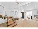 Bright entryway features tile flooring, a modern staircase, and a decorative mirror, creating an inviting welcome at 309 E Huntington Dr, Tempe, AZ 85282