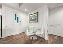 Bright dining area with a modern glass table, white chairs, and artwork, creating a stylish space at 3131 N Central Ave # 6010, Phoenix, AZ 85012