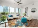 Inviting living room with large windows, wood floors, and a colorful rug, blending comfort and style at 3131 N Central Ave # 6010, Phoenix, AZ 85012