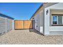 Side yard featuring secure wooden gate access, providing privacy and functionality to the property at 32017 N Redding St, Wittmann, AZ 85361