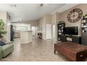 Spacious living area with open layout, tile flooring, and a large decorative clock on the wall at 3313 W Five Mile Peak Dr, San Tan Valley, AZ 85144
