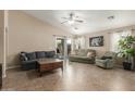 Comfortable living room with tile floors, neutral walls, and a ceiling fan with lots of natural light at 3313 W Five Mile Peak Dr, San Tan Valley, AZ 85144