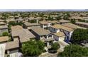 Wide aerial view of a neighborhood with uniform tile roofs, highlighting community layout and landscape at 3330 E Carla Vista Dr, Gilbert, AZ 85295